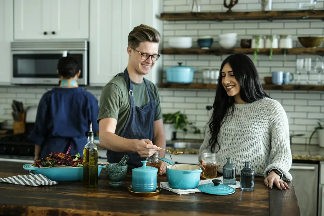 Two people cooking together in a kitchen